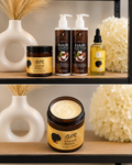 A set of hair care products from GDR Hair Care arranged on a shelf, including a Growth Butter jar, a pump bottle of Hair Shampoo, a pump bottle of Hair Conditioner, and a small dropper bottle of Oil. The products are styled with decorative white vases and dried grass against a neutral background.